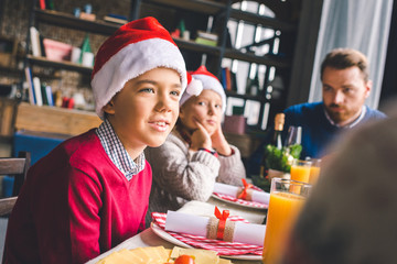kids sitting at christmas table with father