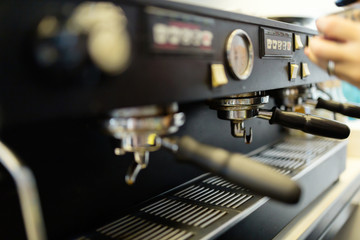 Barista making fresh coffee with machine
