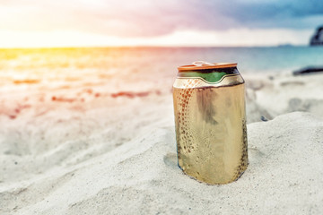 A can of beer on the beach