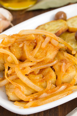 fried cod fish with onion and olive oil on dish