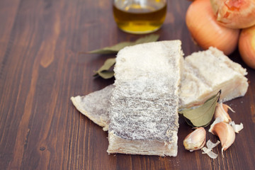raw codfish on brown background