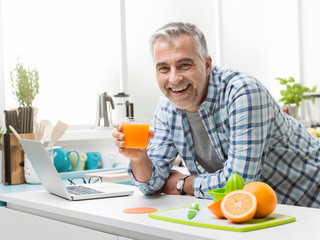 Man having a glass of fresh orange juice