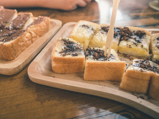 Close up condensed milk toast and chocolate topping on selective focus