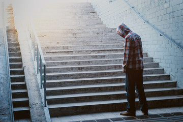 Loneliness man standing back in subway underground crossing