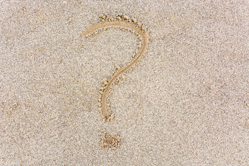 Fototapeta na wymiar Question mark drawn in the sand from above