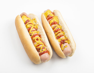 Two hotdogs with ketchup and mustard on white background. Isolated. Food.