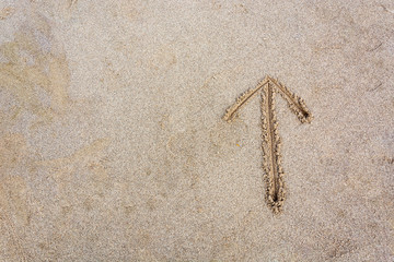 Arrow drawn in the sand from above