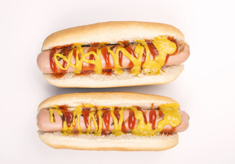 Two hotdogs with ketchup and mustard on white background. Isolated. Food.