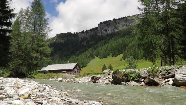alpine&nbsp;herdsmen's&nbsp;hut on mountain river, alm