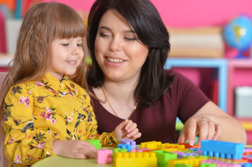 Fototapeta premium little girl playing with mother