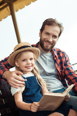 father and daughter with book