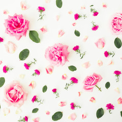 Pattern of flowers with pink roses, petals and leaves on white background. Flat lay, top view. Floral background