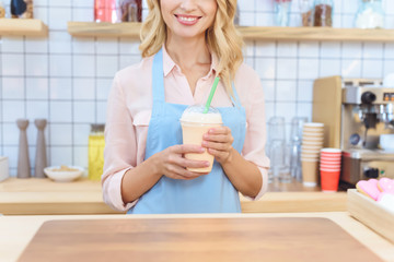 waitress holding milkshake