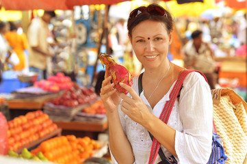 woman holding exotic fruit