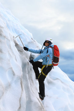 The Girl Climbing On The Glacier. Falljokull Glacier (Falling Glacier) In Iceland