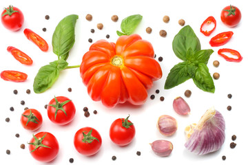 mix of slice of tomato, basil leaf, garlic and spices isolated on white background. top view