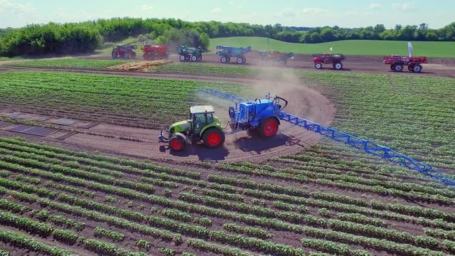 Agriculture irrigation system. Agriculture fertilizer working in agricultural field. Agricultural pesticide sprayer on farming field. Farming machinery fertilizer field. Fertilizer spreader working