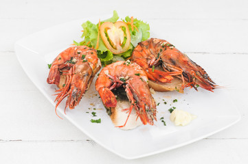 Prawn dish on the toasted bread with salad and garlic 
