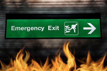Emergency exit sign green color with light and arrow pointing to exit gate with while fire. safety...