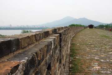 Fototapeta na wymiar Nanjing Old City Wall with a view of the City and Mountain. Nanjing, China. 16th, April, 2009