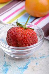 Close-up detail of a fresh red strawberry with leaves
