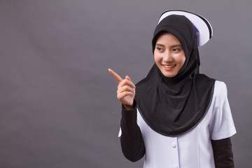 muslim nurse pointing up finger