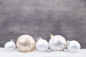 Silver Christmas balls on shiny background.