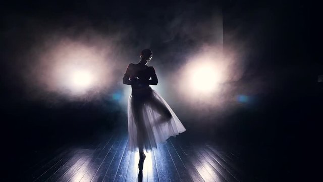 A ballerina walks to the camera in dancing movements. 