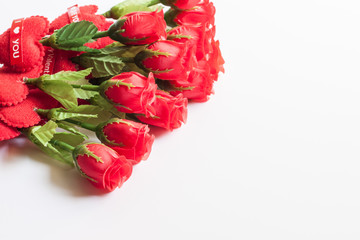 Roses and red heart on white background