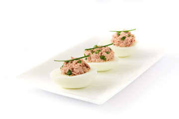 Stuffed eggs with tuna isolated on white background