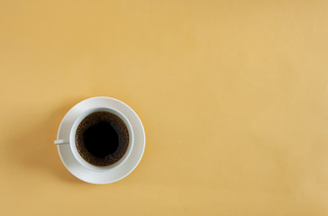 Cup of coffee on yellow background