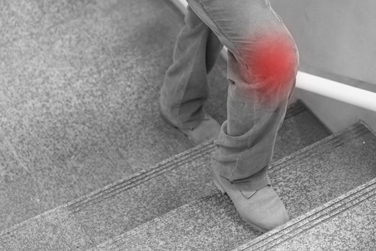 knee joint pain concept, leg stepping up on stairs