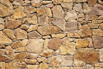 Old beige big stone wall background texture close up