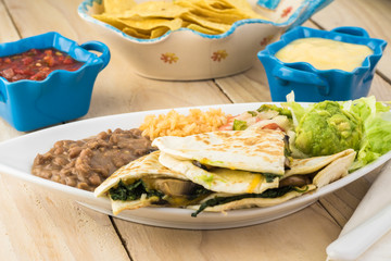 Spinach mushroom quesadillas with refried beans and rice.