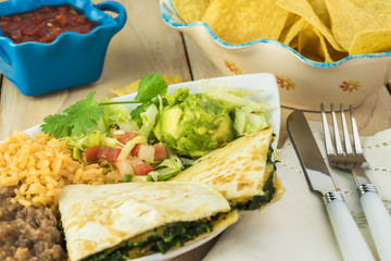 Spinach mushroom quesadillas with refried beans and rice.