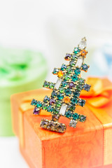 Merry Christmas and Happy New Year. Vintage brooch Christmas tree and a gift box