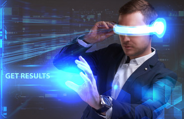 Business, Technology, Internet and network concept. Young businessman working in virtual reality glasses sees the inscription: Get results