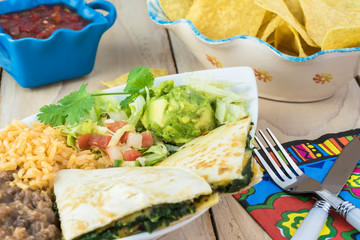 Spinach mushroom quesadillas with refried beans and rice.