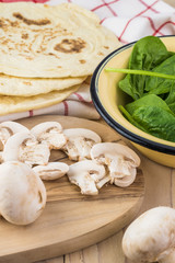 Fototapeta premium Ingredients for spinach mushroom quesadillas.