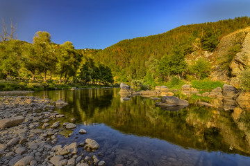Fototapeta na wymiar beautiful reflections in the water of a mountain river
