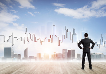 Motivation and inspiration concept with modern cityscape and businessman observing it