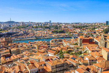 Fototapeta na wymiar Picturesque Oporto urban landscape on Douro River and city skyline from Clerigos Tower, the highest point in the city of Porto. Beautiful cityscape in a sunny day