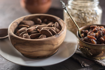 Almond with raisins in a dish of wood