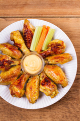 Chicken wings buffalo with cheese dip. View from above, top studio shot, vertical