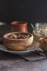 Almond with raisins in a dish of wood