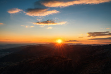 Colorful sunset on top of mountain alps