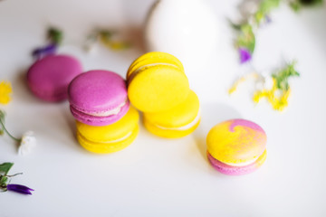 Morning cup of coffee, cake macaron, gift or present box and flower on light table from above. Beautiful breakfast. Flat lay style.