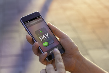 Woman using contemporary modern smartphone to make an online payment. Shopping online concept