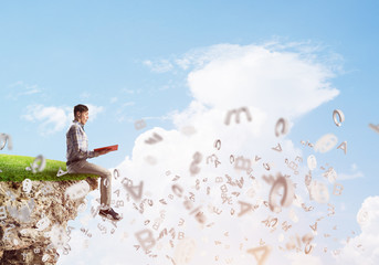 Student guy in suit with book in hands preparing for exam