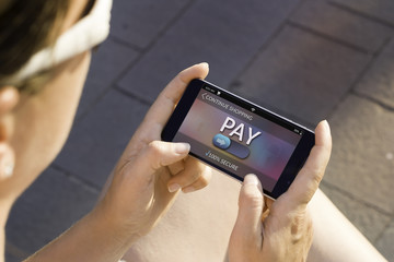 Woman using contemporary modern smartphone to make an online payment. Shopping online concept